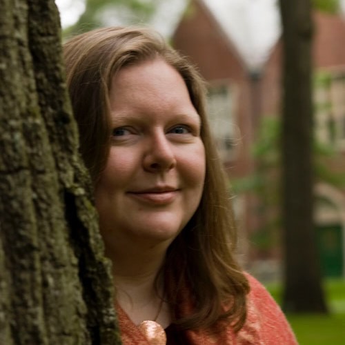 Jennie Gottschalk peering from behind a tree.