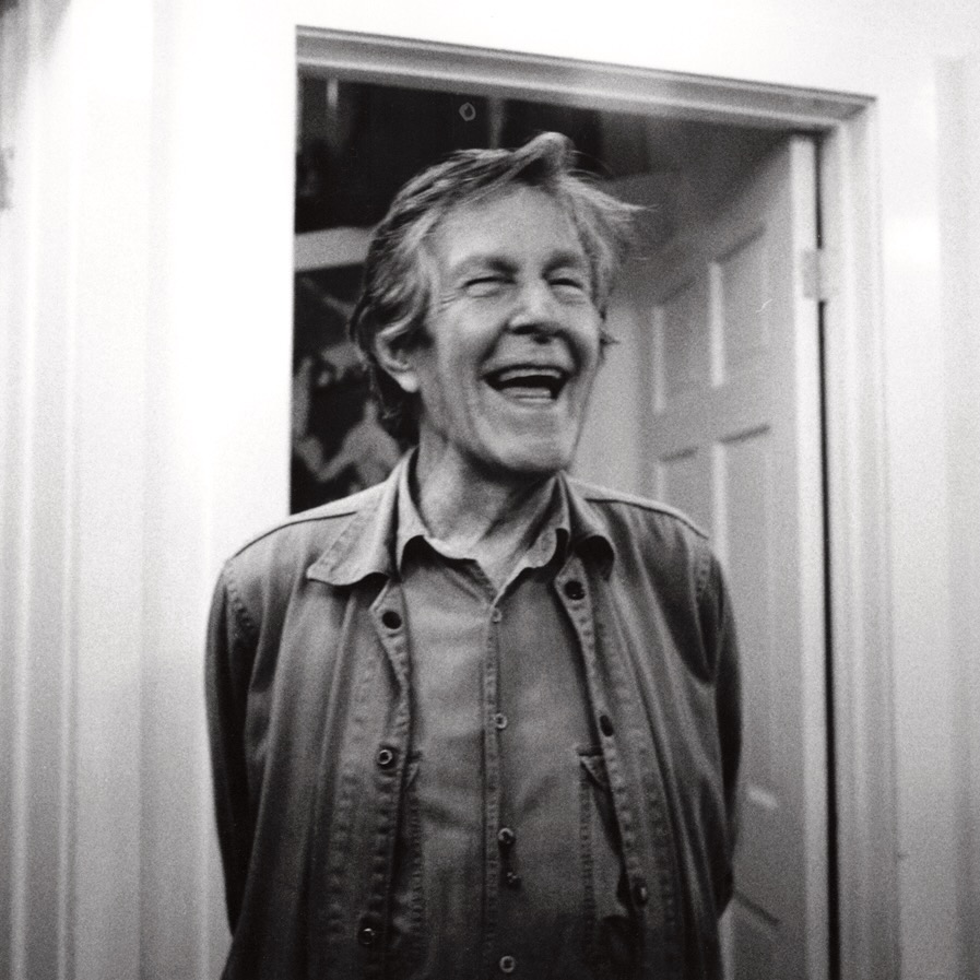 John Cage smiling.