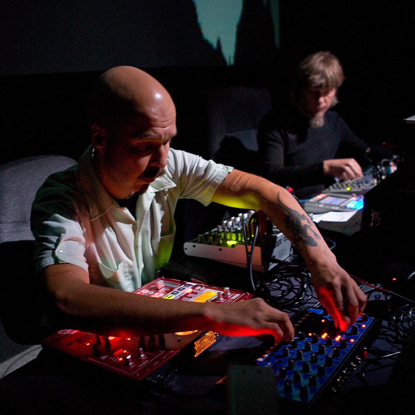 Two electronics performers on stage.